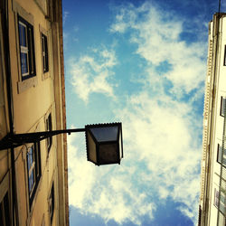 Low angle view of building against cloudy sky