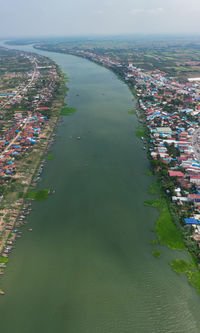 High angle view of buildings by sea against sky