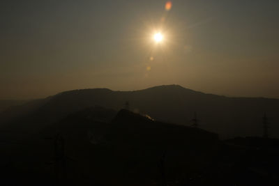 Scenic view of silhouette mountains against sky during sunset