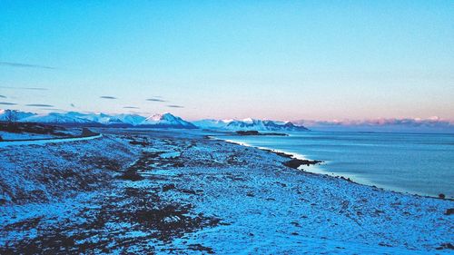 Scenic view of sea against clear sky during winter