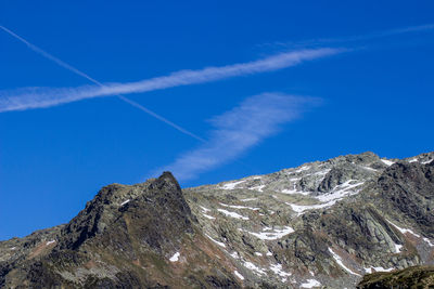 Low angle view of vapor trail against blue sky