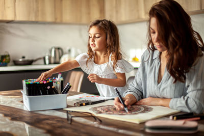 Mother and daughter drawing art on paper