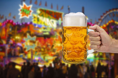 Close-up of hand holding beer glass