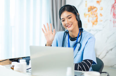 Young woman using laptop on table