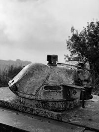 Abandoned truck on field against sky