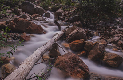 Stream flowing through rocks in forest