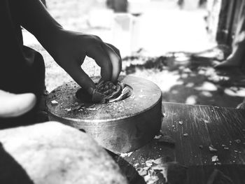 Close-up of man cracking walnuts