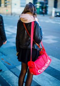 Rear view of woman with umbrella standing in winter