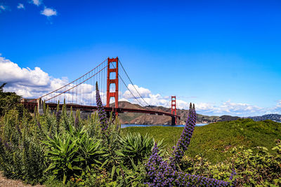 View of suspension bridge against cloudy sky