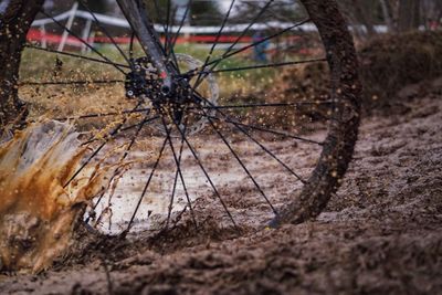 Close-up of damaged bicycle on field