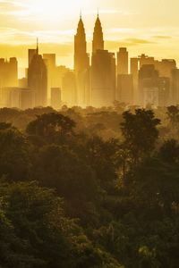 Buildings in city at sunset