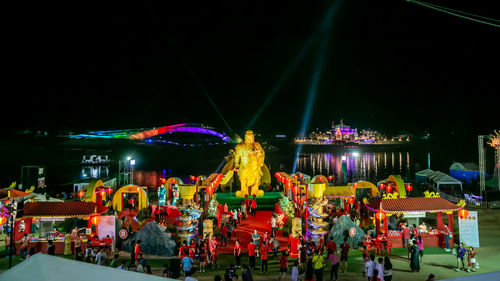 Group of people in amusement park at night