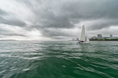 Sailboat in sea against sky