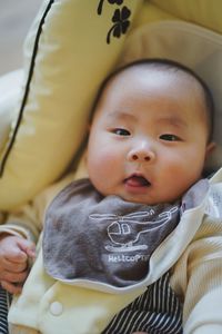 Portrait of cute baby boy sleeping on bed at home