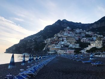 Panoramic shot of sea and buildings against sky