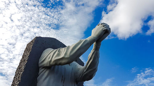 Low angle view of statue against blue sky