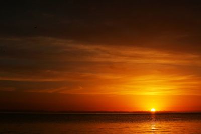 Scenic view of sea against orange sky