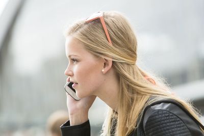 Side view of woman talking on smart phone