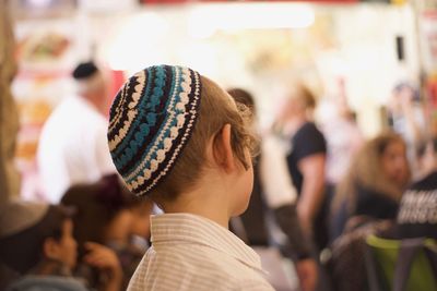 Close-up of boy wearing skull cap