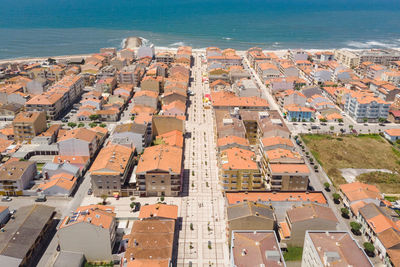 Aerial view of cityscape by sea