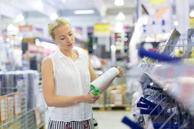 Mid adult woman standing in departmental store