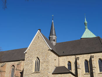 Low angle view of building against clear blue sky