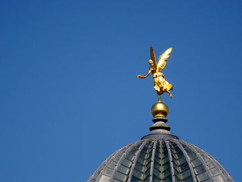 Low angle view of built structure against clear blue sky