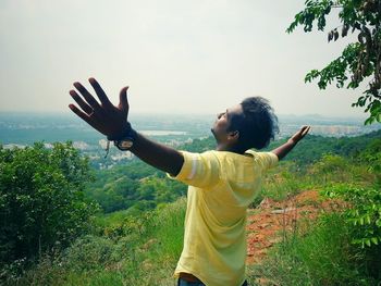 Close-up of a man with arms raised