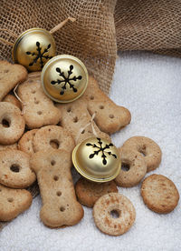 Dog treats with christmas ornaments on neutral tabletop
