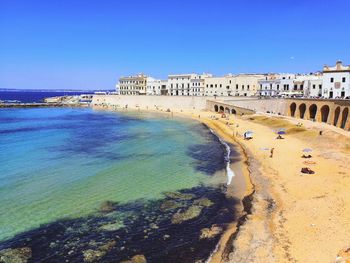 Panoramic view of sea and buildings against clear sky