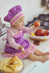 High angle view of cute girl eating food at home