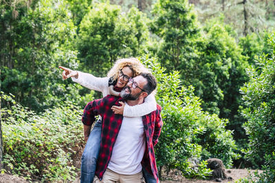 Rear view of couple kissing in forest