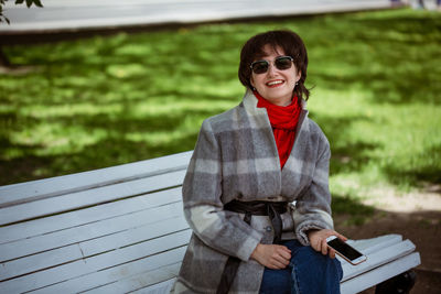 Portrait of smiling young woman standing outdoors