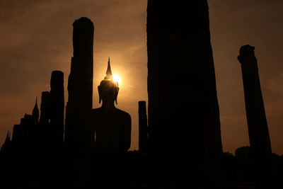 Silhouette of a statue of buddha in wat mahathat temple