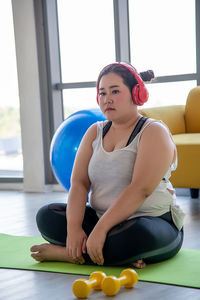 Portrait of young woman sitting on table