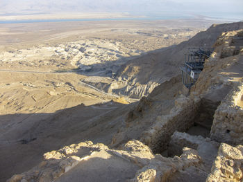 High angle view of land and mountains against sky masada