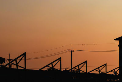 Silhouette bridge against sky during sunset