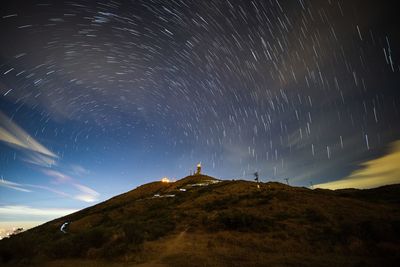 Mountain against startrails at night