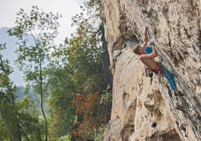 Man climbing on the limestone cliff "white mountain" in yangshuo