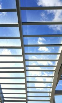 Low angle view of window against blue sky