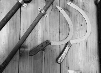 High angle view of chain hanging on wooden table