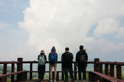 Low angle view of people standing against sky