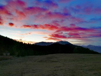 Scenic view of mountains against sky at sunset