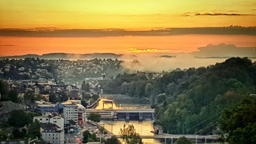 Aerial view of townscape against sky during sunset