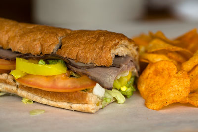 Close-up of beef sandwich with potato chips