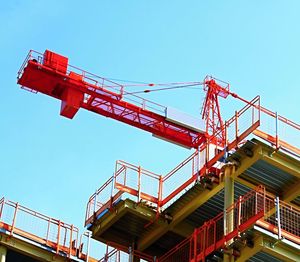 Low angle view of crane against clear blue sky stock photo