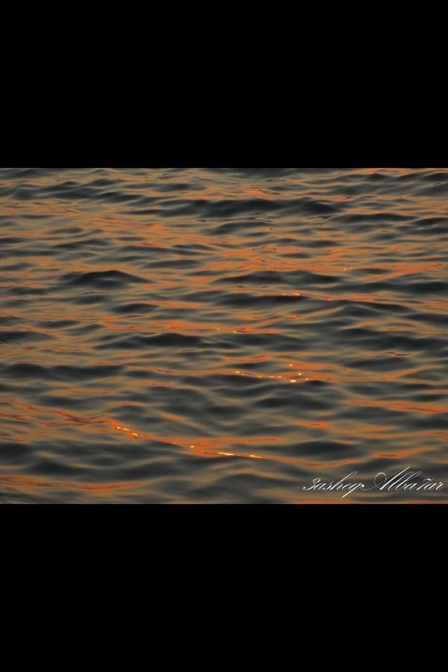 sunset, water, silhouette, orange color, scenics, copy space, dark, motion, night, tranquil scene, sky, beauty in nature, long exposure, nature, no people, rippled, sea, outdoors, tranquility, illuminated