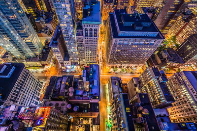 High angle view of illuminated buildings and street in city