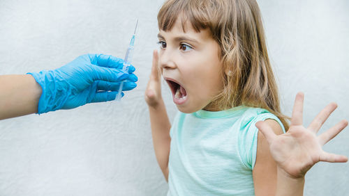 Close-up of girl blowing bubbles