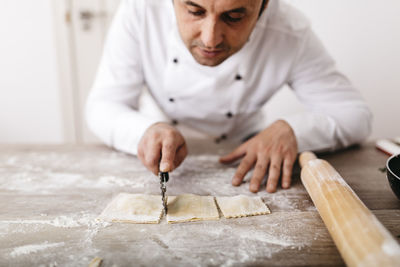 Chef cutting fresh ravioli